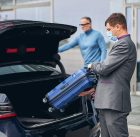 chauffeur-standing-by-the-vehicle-with-the-open-bo-2021-09-03-09-42-18-utc